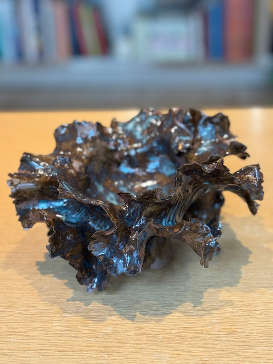Metallic blue coral-like sculpture on a wooden surface with blurred bookshelf in the background, Large Vase Choux – Handmade Ceramic – Nathalie Reignault Sann