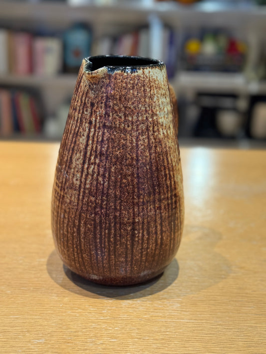 Textured brown ceramic vase on a wooden surface with a blurred bookshelf background, Mid-Century Vintage Vase/Pitcher – French Stoneware – Maison Holder