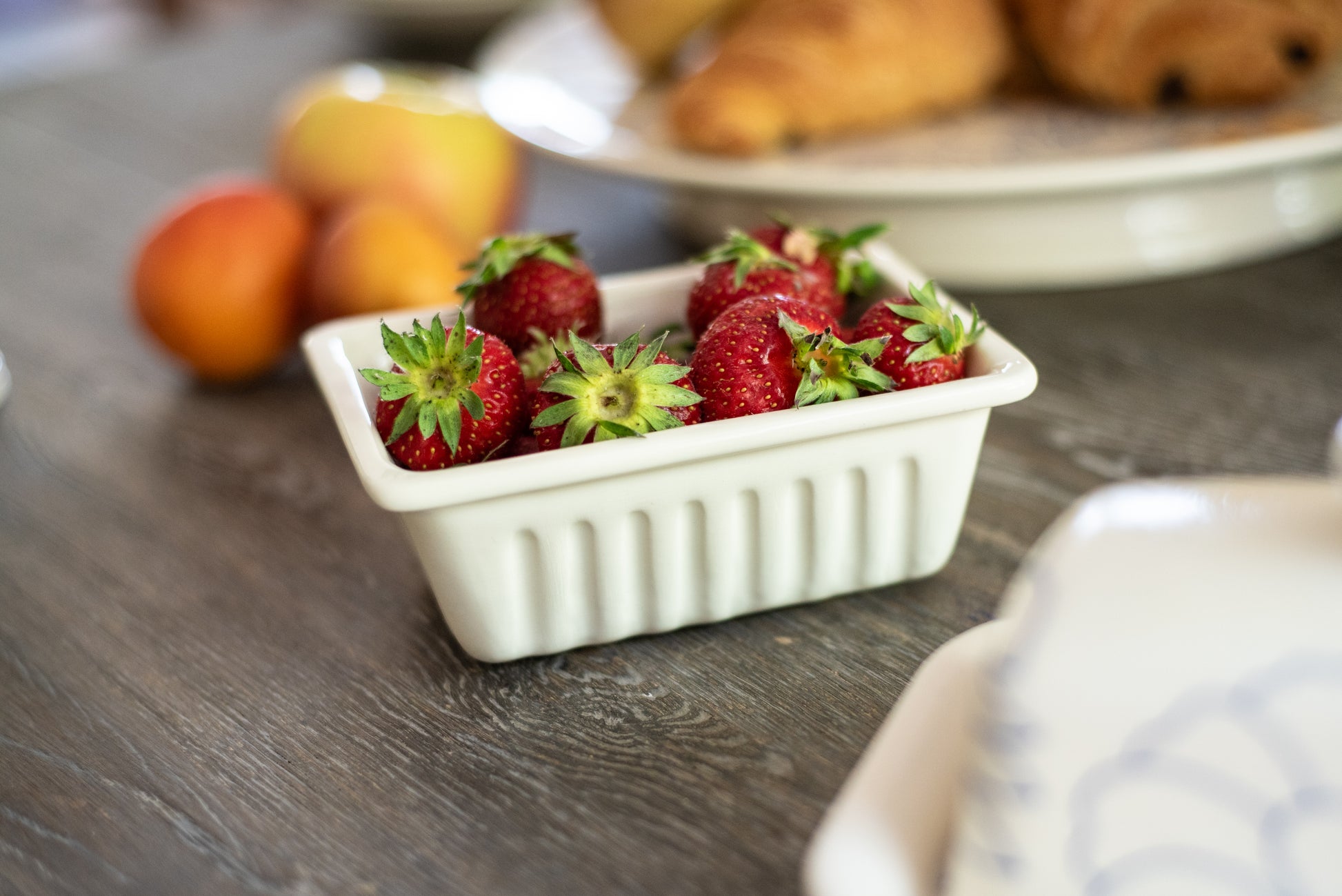 Container of strawberries on a wooden table with blurred background, Medium French Fries Tray – Desvres Earthenware – Maison Holder