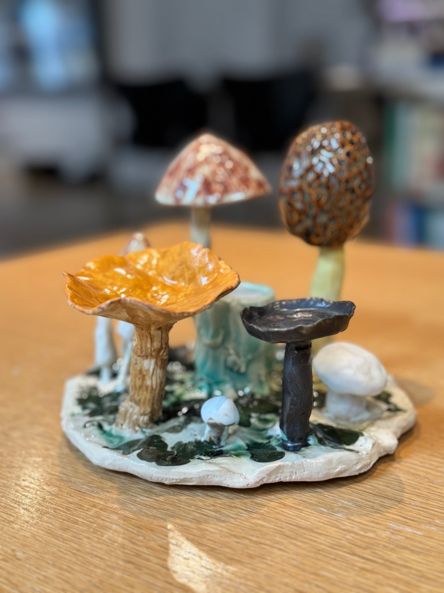 Collection of ceramic mushrooms on a wooden surface, Mushroom Candles – Handmade Ceramic – Nathalie Reignault Sann