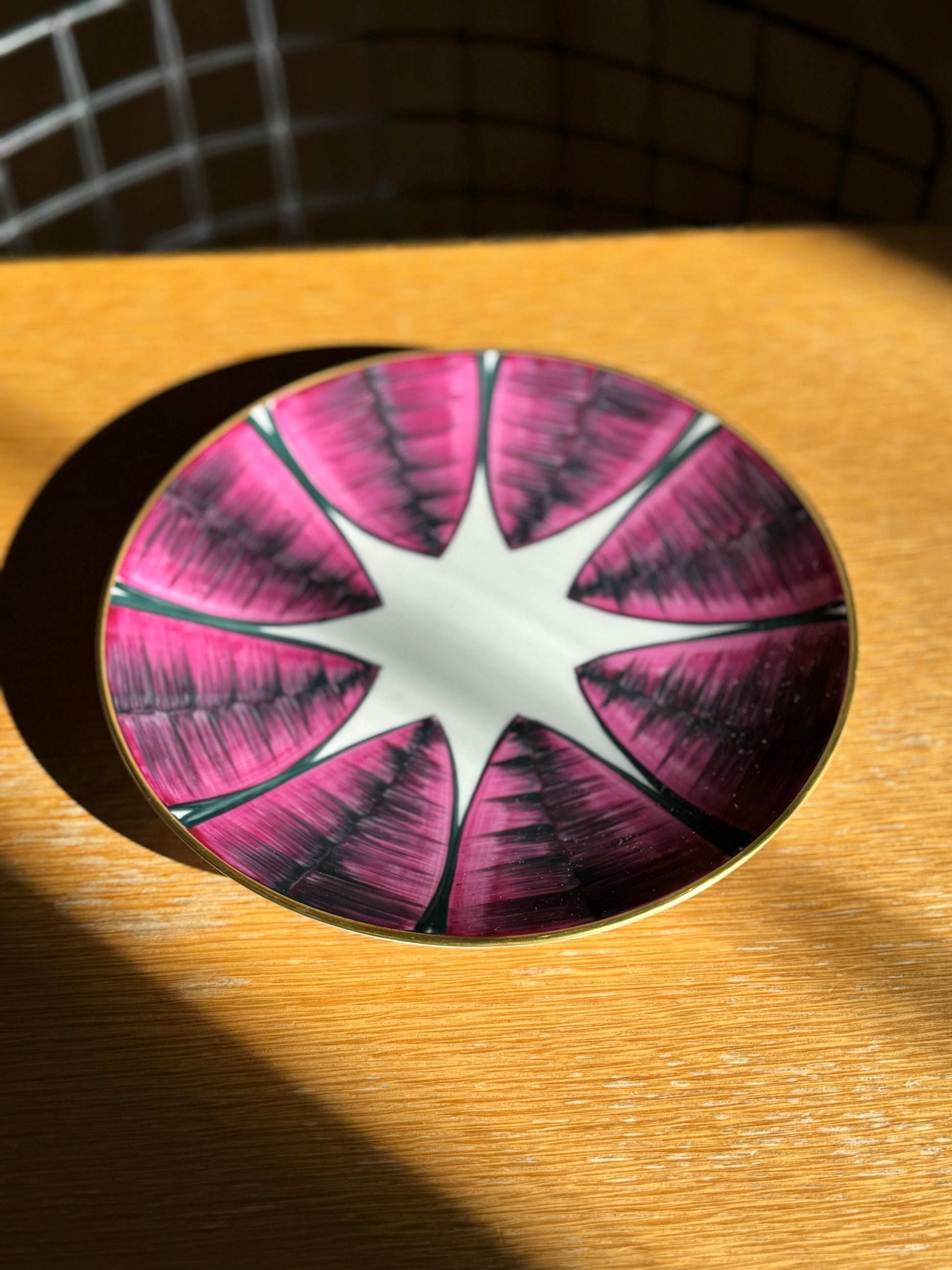 Decorative plate with pink and white design on a wooden surface, Agave Hand-Painted Dessert Plate – Porcelain – Marie Daâge