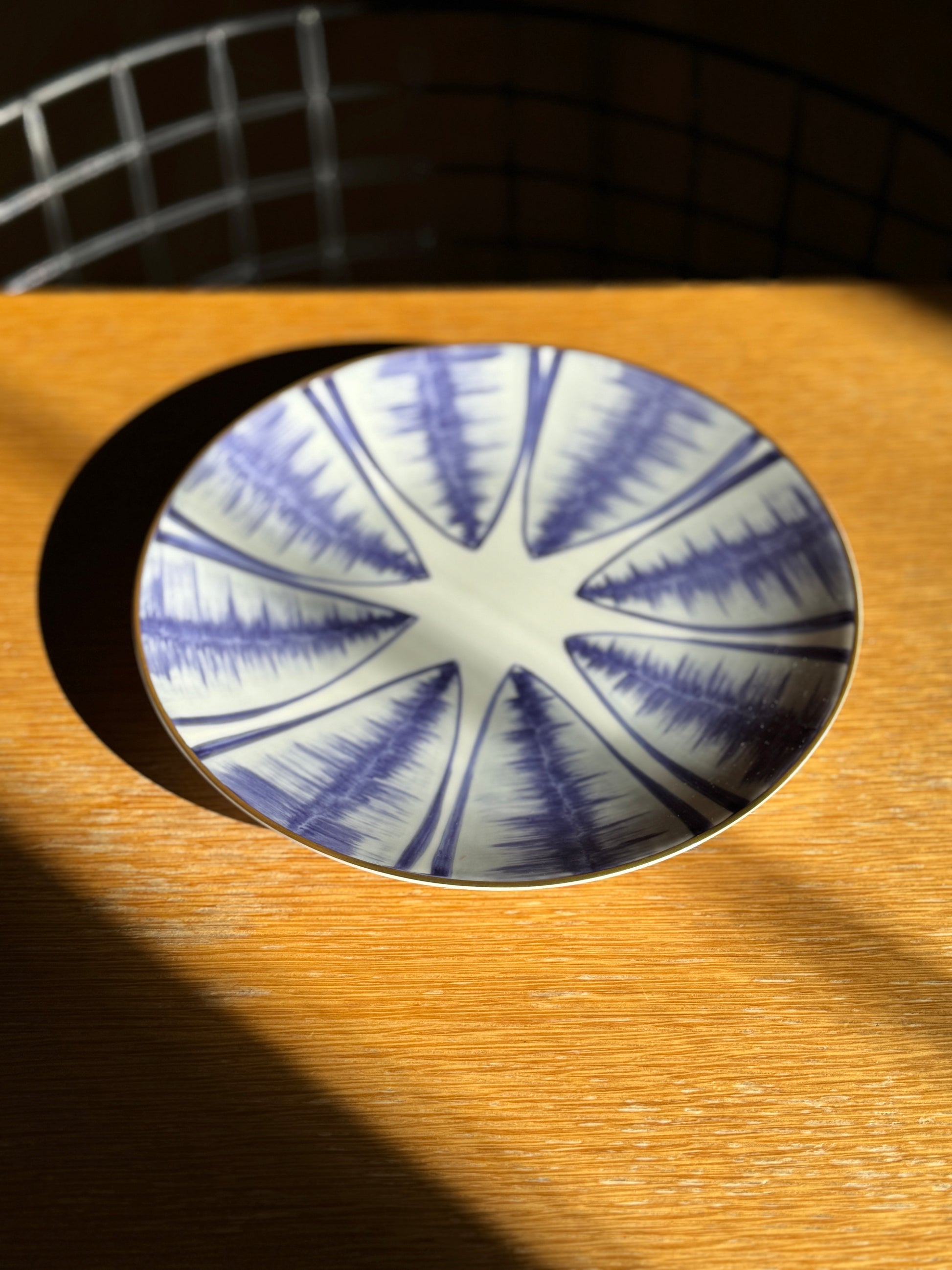 Blue and white ceramic coaster on a wooden surface, Agave Hand-Painted Dessert Plate – Porcelain – Marie Daâge