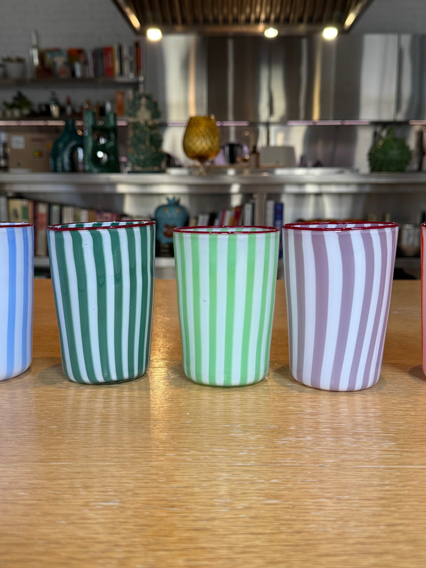 Set of striped glasses  on a wooden floor with a blurred background, Joyful Stripe Glasses – Murano Cane Glassware – Maison Holder