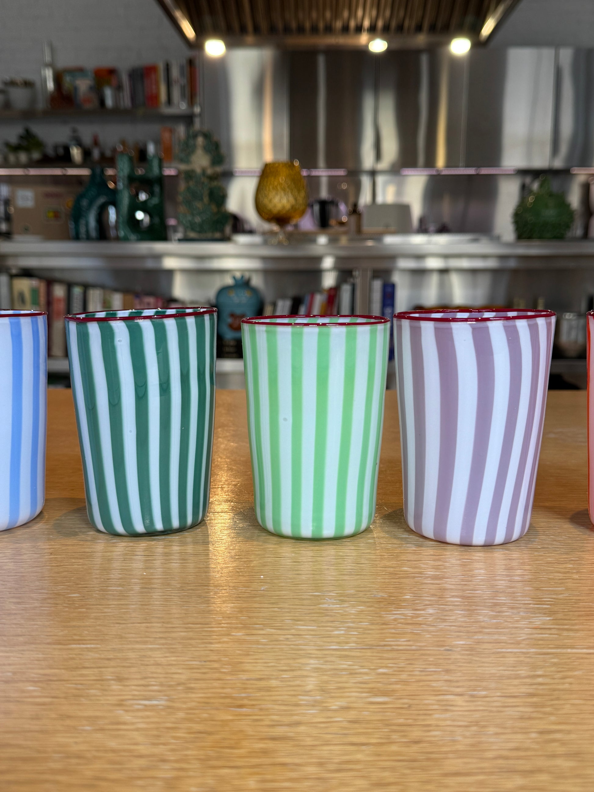 Set of striped glasses  on a wooden floor with a blurred background, Joyful Stripe Glasses – Murano Cane Glassware – Maison Holder