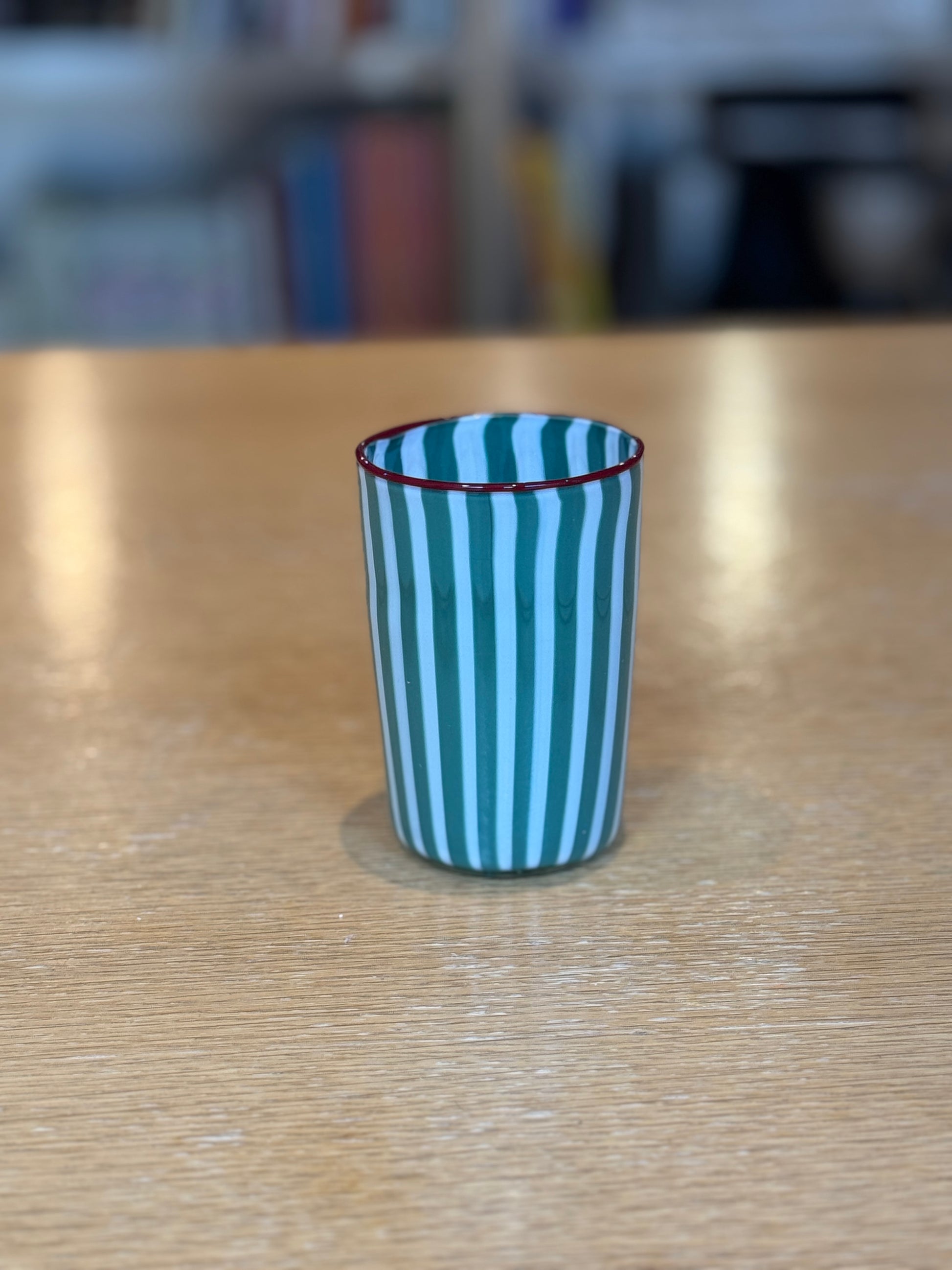 Striped cup on a wooden table with a blurred background, Joyful Stripe Glasses – Murano Cane Glassware – Maison Holder