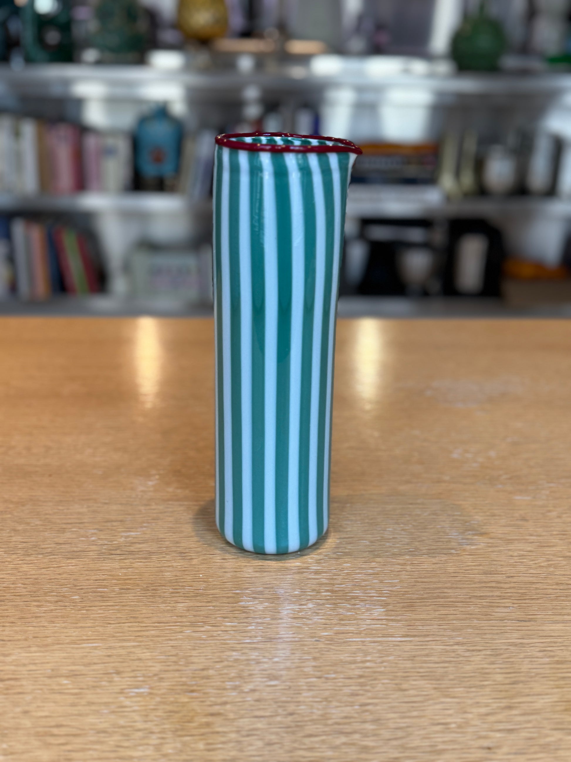 Striped glass vase on a wooden surface with a blurred background, Joyful Stripe Pitcher – Murano Glass by France Thierard – Maison Holder
