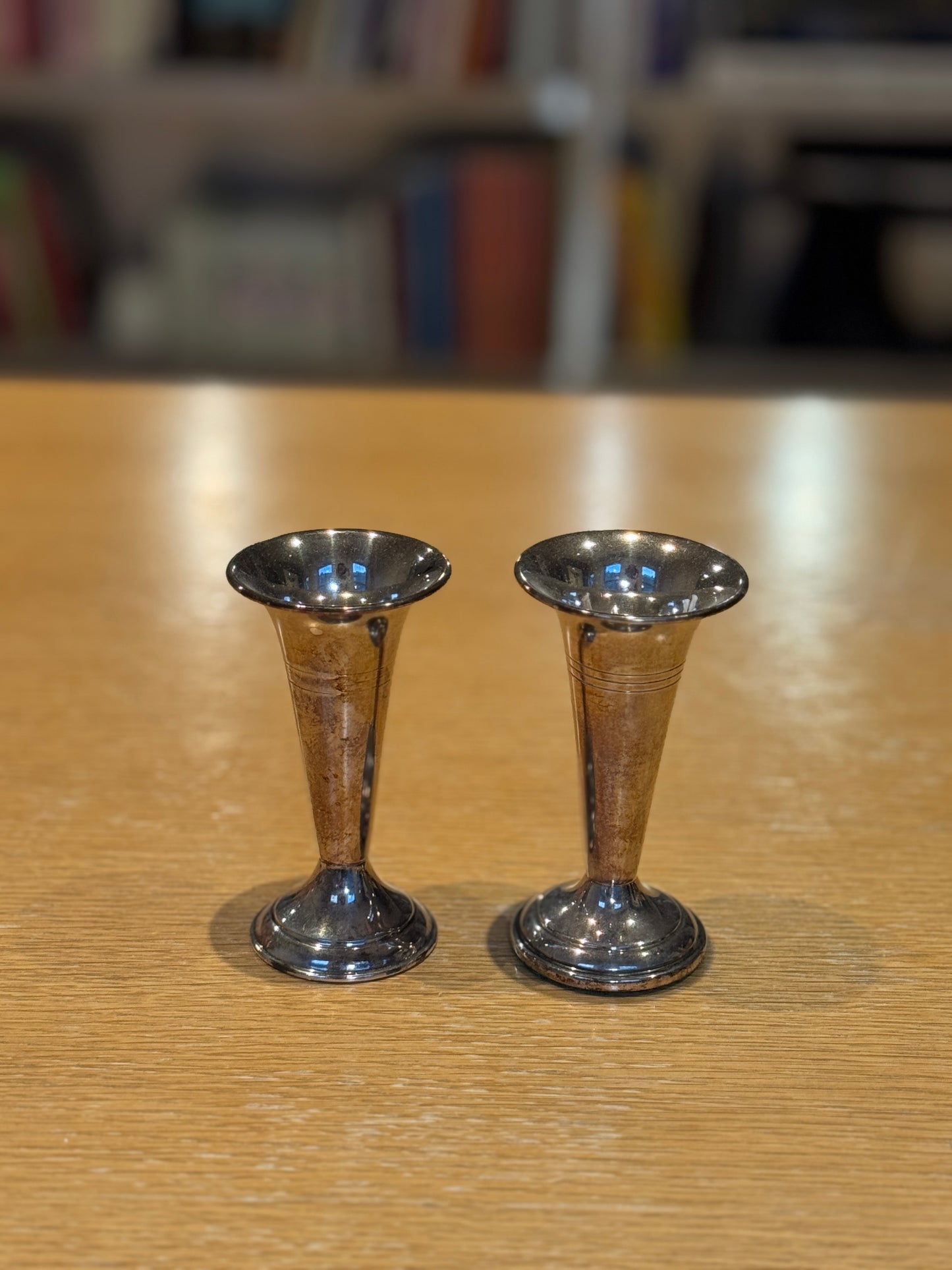 Two silver candle holders on a wooden surface with a blurred background, Pair of Silver-Plated Candle Holders 1950s – Maison Holder