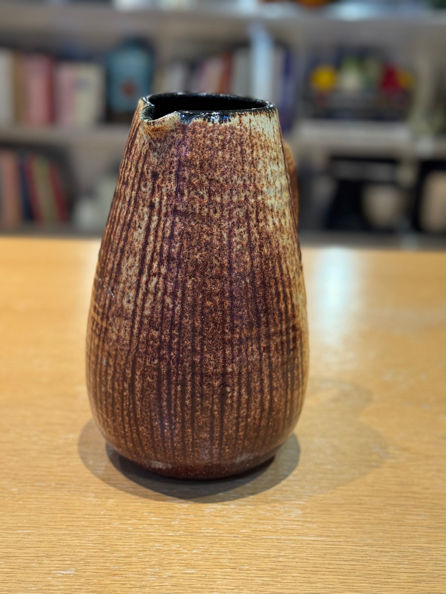 Textured brown ceramic vase on a wooden surface with a blurred bookshelf background, Mid-Century Vintage Vase/Pitcher – French Stoneware – Maison Holder