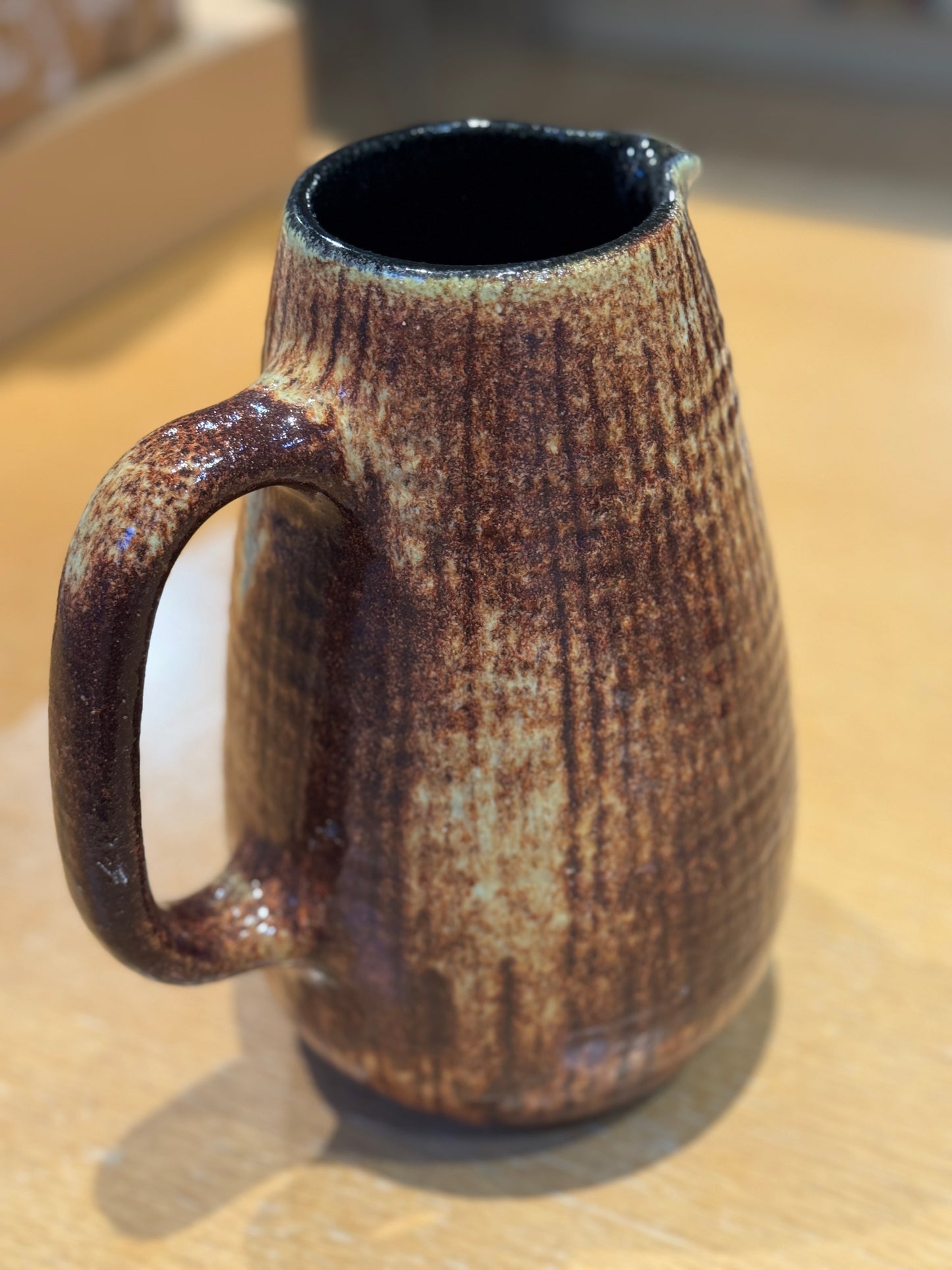 Brown ceramic mug with textured surface on a wooden surface, Mid-Century Vintage Vase/Pitcher – French Stoneware – Maison Holder