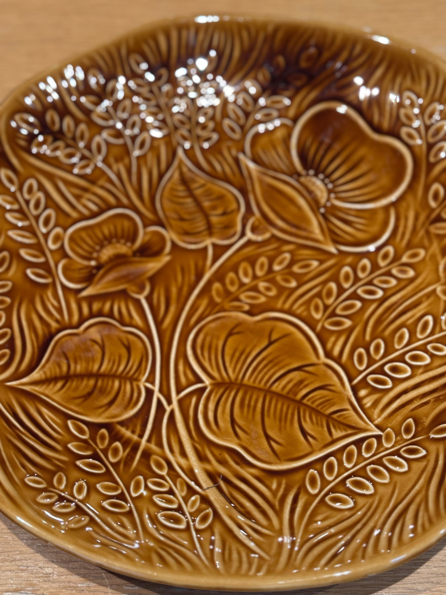 Brown ceramic plate with floral embossing on a wooden surface, Sarreguemine Charger Plate – Mid-Century French Ceramic – Maison Holder