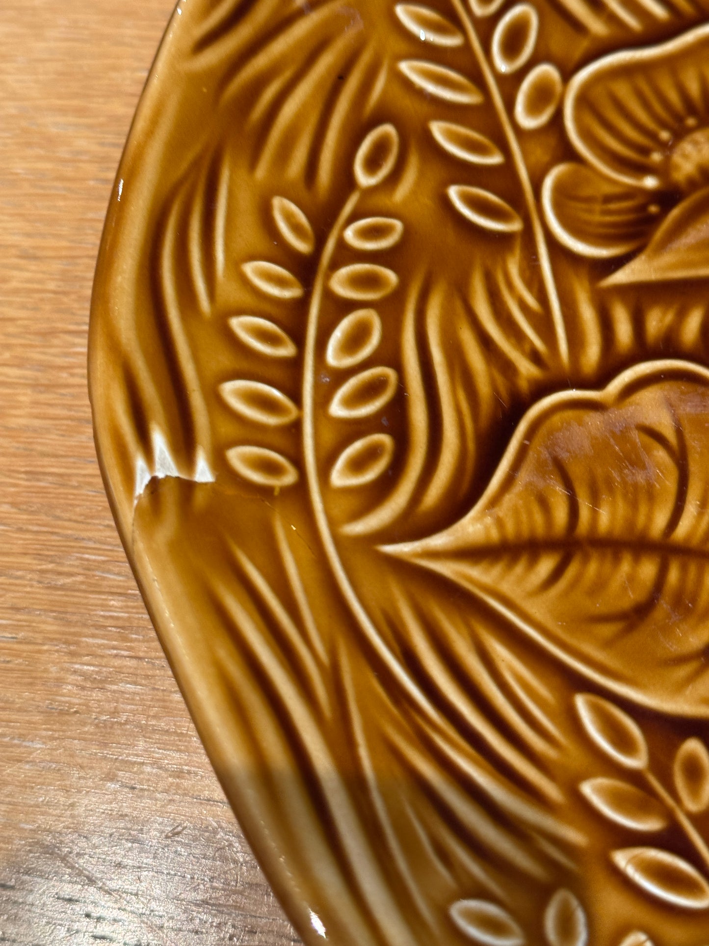 Brown ceramic plate with leaf patterns on a wooden surface, Sarreguemine Charger Plate – Mid-Century French Ceramic – Maison Holder