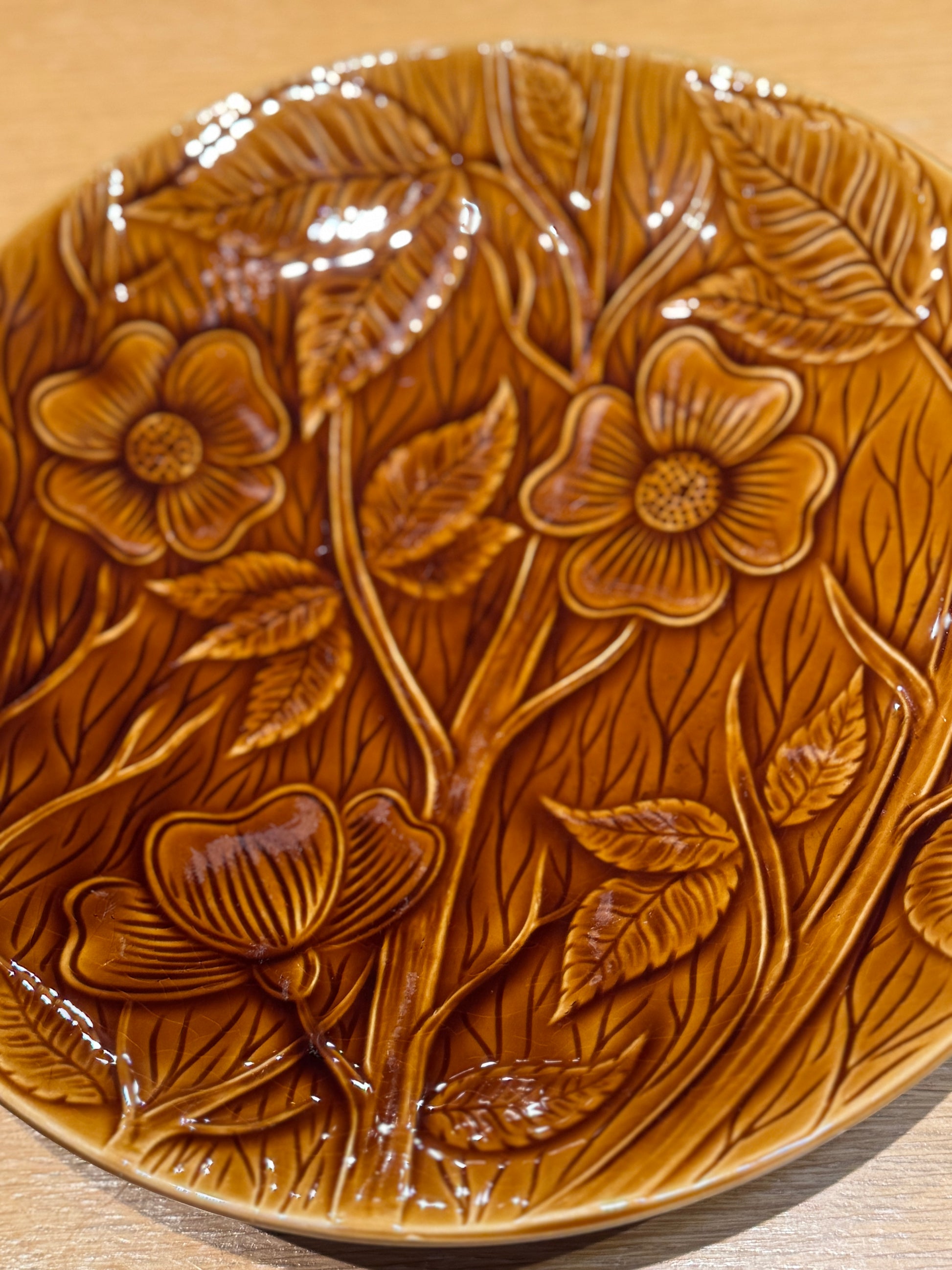Brown ceramic plate with floral and leaf patterns on a wooden surface, Sarreguemine Shallow Bowl – Mid-Century French Ceramic – Maison Holder