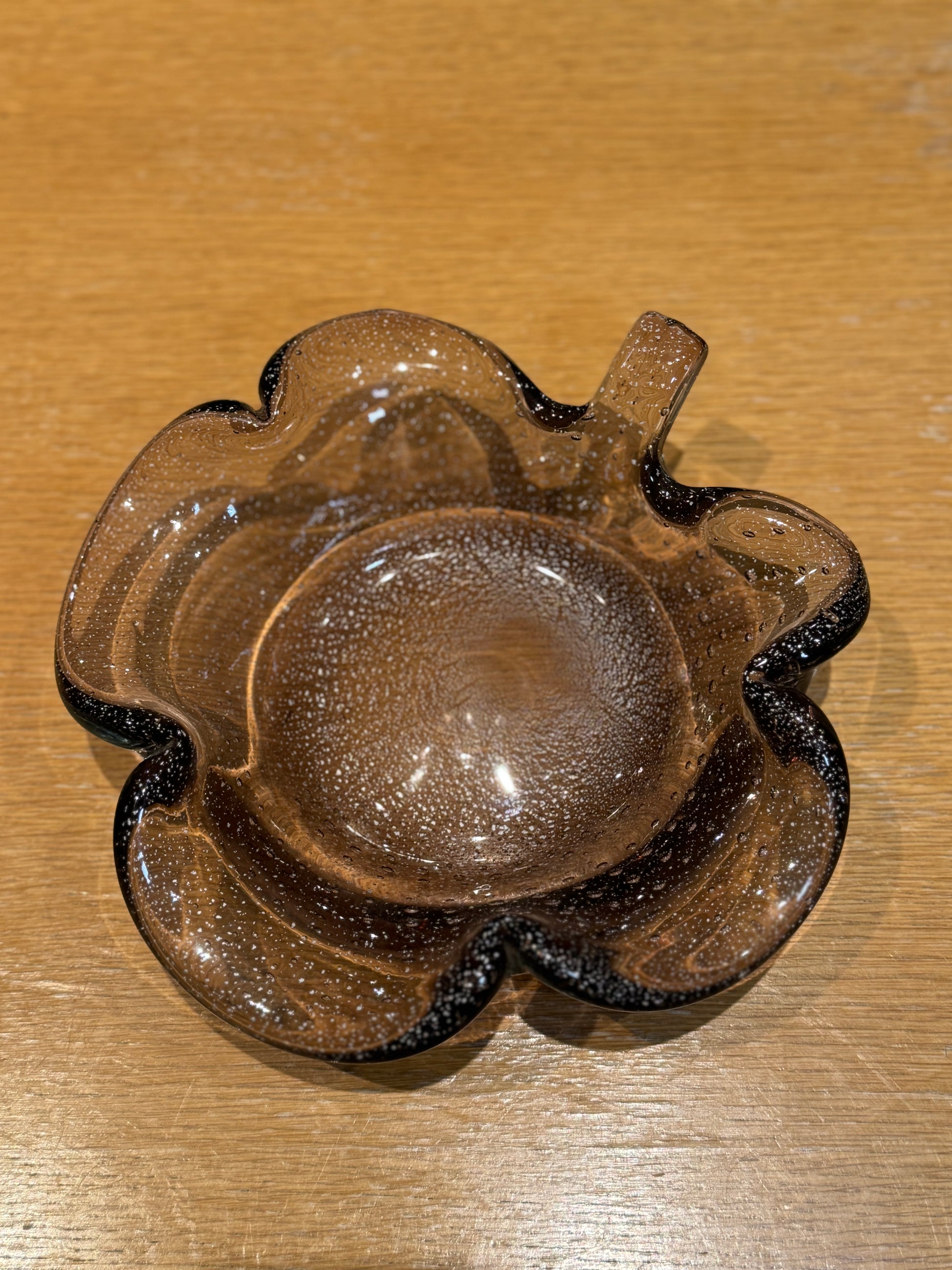 Brown glass ashtray on a wooden surface, Murano Glass Bowl 1960s vintage