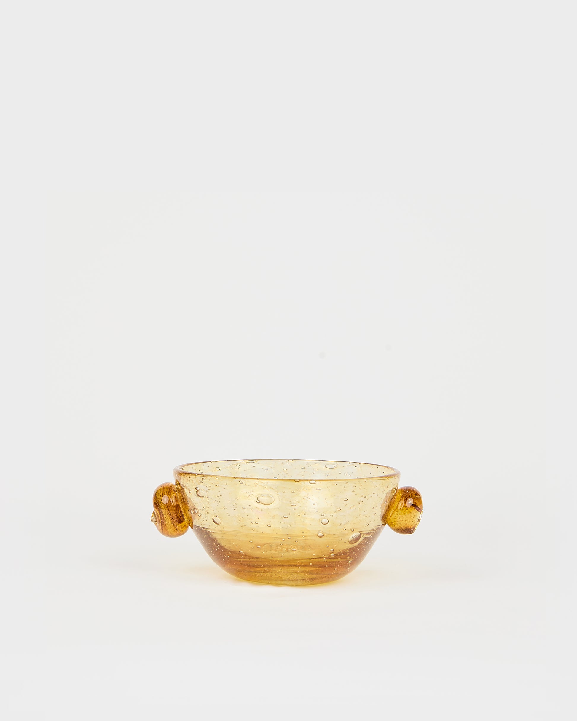 Amber glass bowl with handles on a white background, Poppy Cup – La Romaine Editions Bubble Glass – Maison Holder