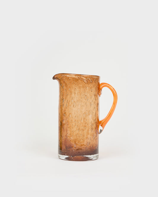 Brown glass pitcher with a handle on a white background, Bubble Glass Carafe – La Romaine Editions – Maison Holder