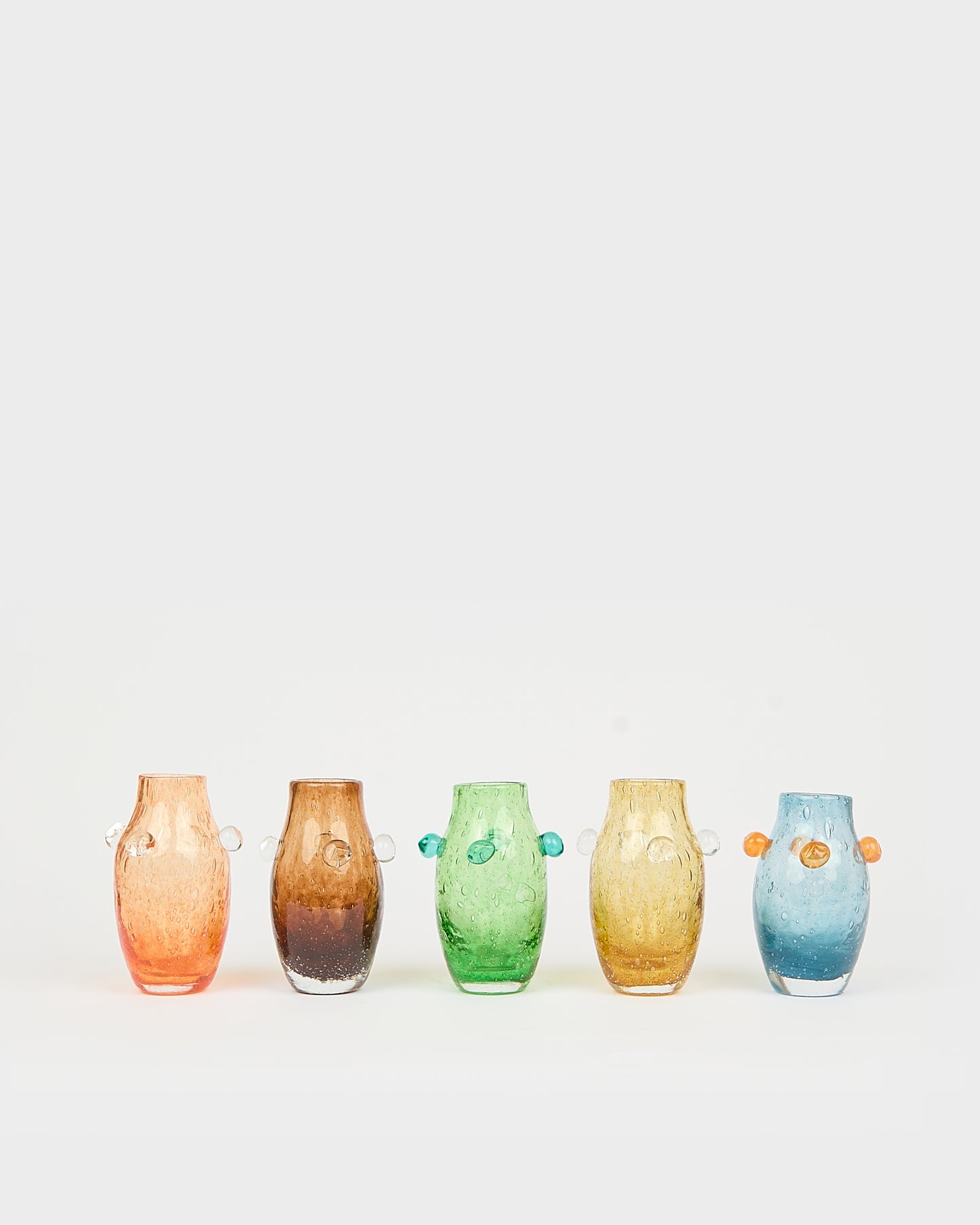 Five colorful vases of different shapes and sizes on a white background, Little Daisy Vase – La Romaine Editions – Maison Holder