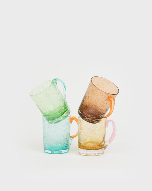 Three colorful glass mugs stacked on a white background, Artisanal Bubble-Glass Mug – La Romaine Editions – Maison Holder