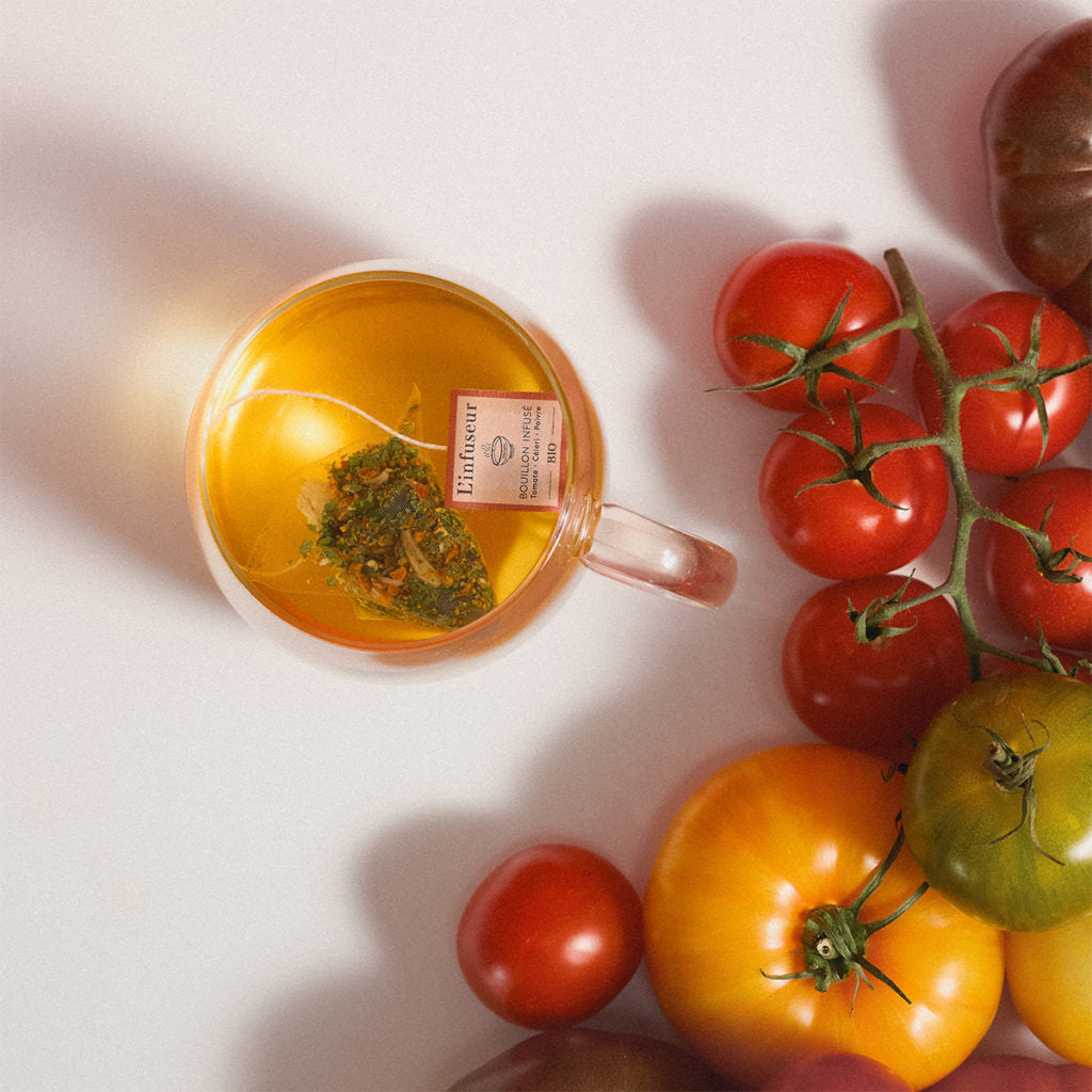 Tea cup with a tea bag and tomatoes on a white background, Organic Tomato–Celery Broth by L'Infuseur – Vegetable Blend