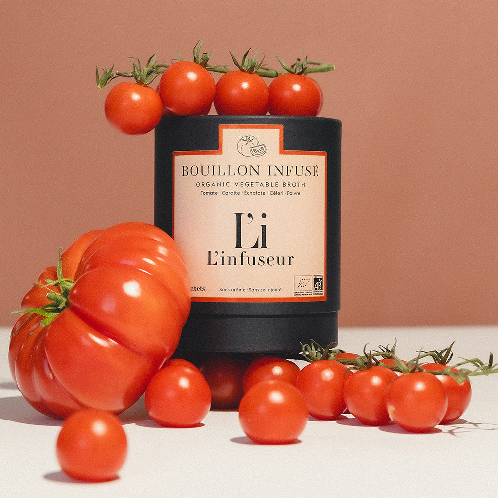 Bottle of Bouillon Infusé with tomatoes on a beige background, Organic Tomato–Celery Broth by L'Infuseur – Vegetable Blend