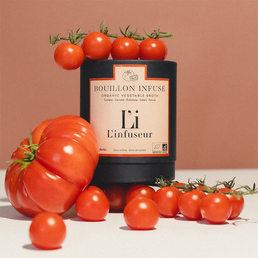 Bottle of Bouillon Infusé with tomatoes on a beige background, Organic Tomato–Celery Broth by L'Infuseur – Vegetable Blend