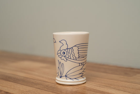 Ceramic cup with blue fish design on a wooden surface, Rouen Decor Molded Mug – Desvres Earthenware – Maison Holder