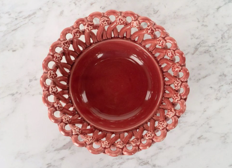 Red ceramic bowl with decorative lace-like rim on a marble surface, Iconic Bread Basket – Maison Pichon