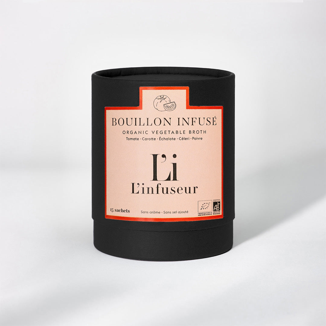 Black container with a pink label featuring text and branding on a white background, Organic Tomato–Celery Broth by L'Infuseur – Vegetable Blend