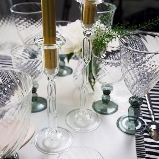 Decorative table setting with glass candlesticks, goblets, and flowers. Infinity Large Candle Holder – Sculptural Glass Art – Maison Holder