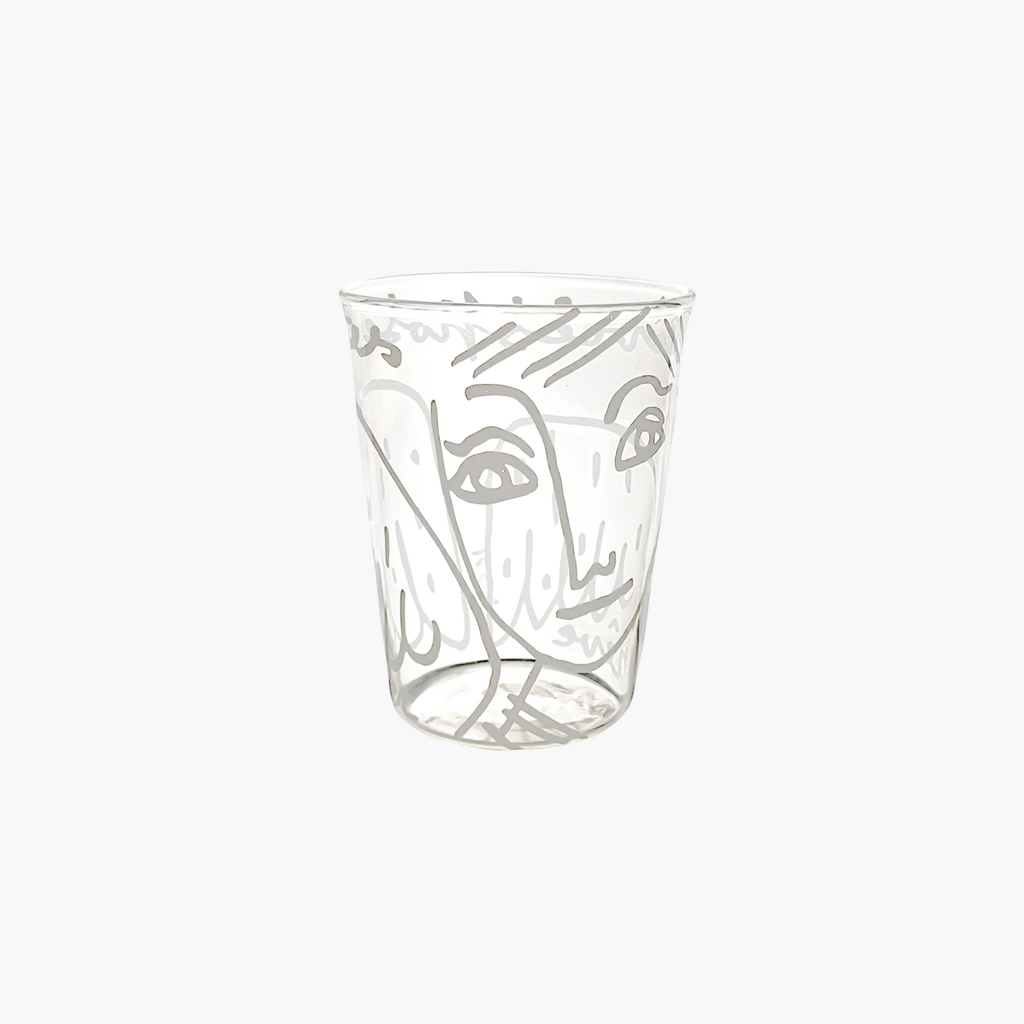 Clear glass tumbler with artistic face design on a white background , Jean-Charles de Castelbajac Angel Tumbler – WAWW