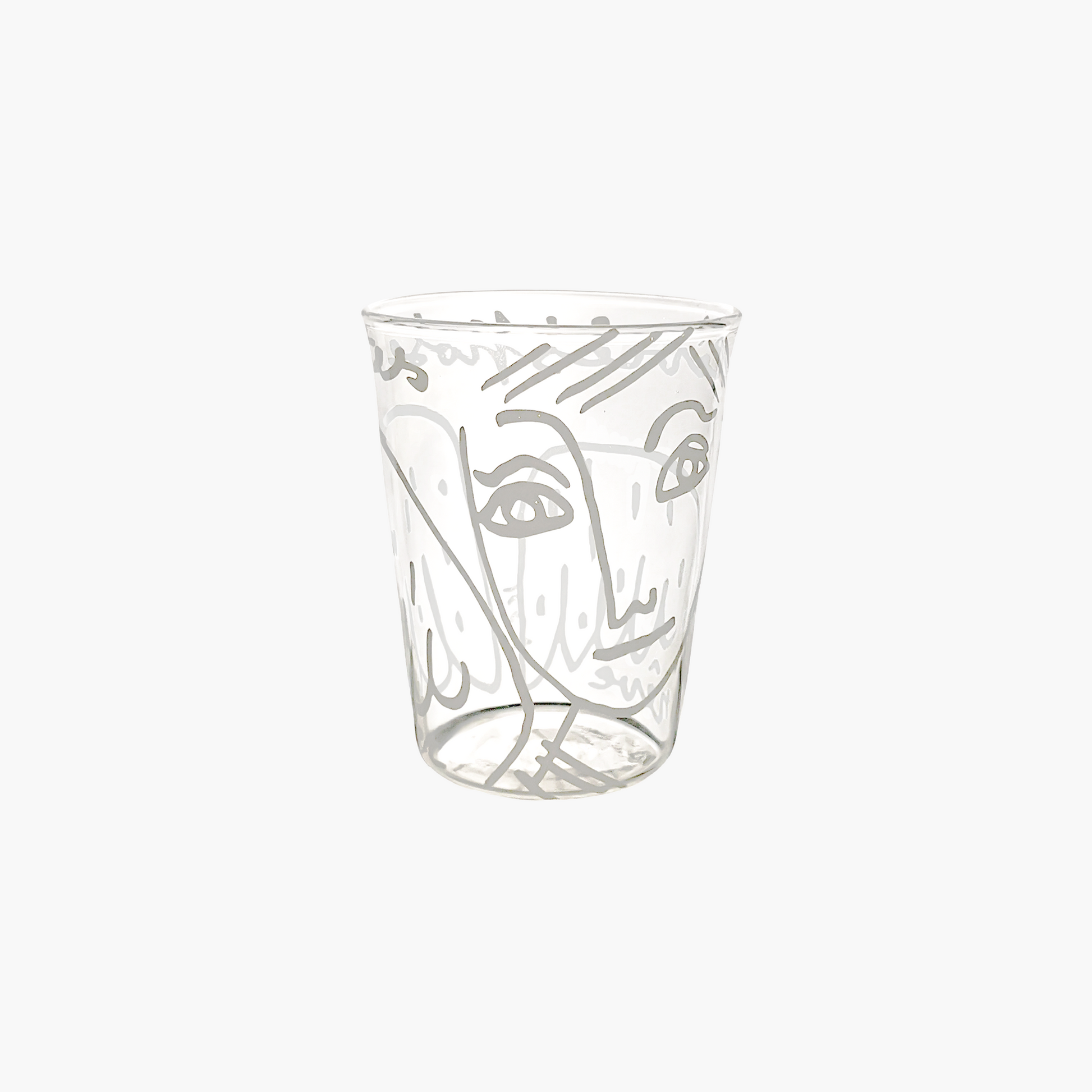 Clear glass tumbler with artistic face design on a white background , Jean-Charles de Castelbajac Angel Tumbler – WAWW
